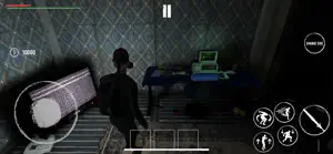 Inside a shack with a mattress, a computer desk and a survivor in the dark