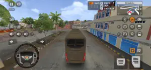 Driving behind a coach on a city street lined with blue shutters, wheel at bottom left