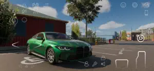 A green sports saloon parked outside a red barn on a sunny lot