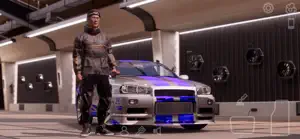 A player in a hoodie beside a blue-and-silver Skyline in a garage