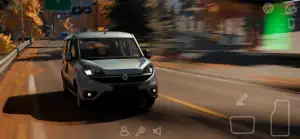 A silver hatchback driving a highway toward a green road sign