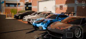 A row of tuned cars parked outside brick shops
