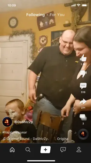Feed video of a family laughing beside a boy with cake on his face, tagged #happynewyear, under Following and For You tabs