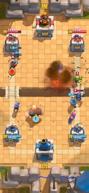 Sandstone arena with a spell exploding beside a tower