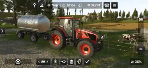 Red Valtra tractor with a milk tanker beside a cattle pen
