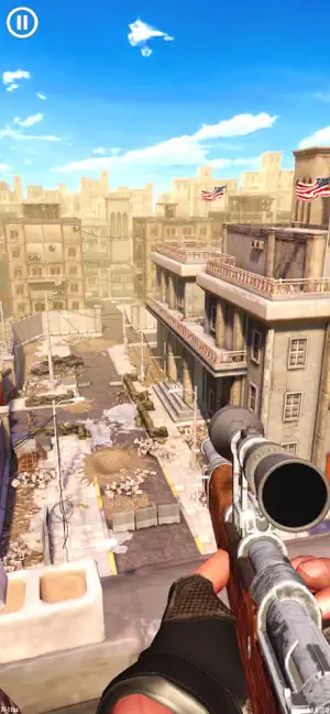 A rifle held over a sun-bleached town with a flag on a distant rooftop