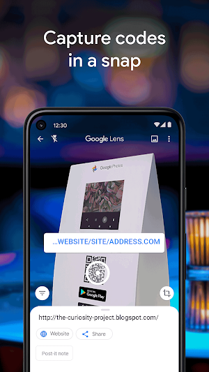 Lens reading a QR code on a Google Photos display box and offering Website and Share buttons for the decoded link