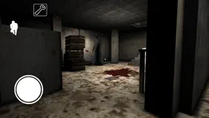 Basement corridor with crates and a bloodstain