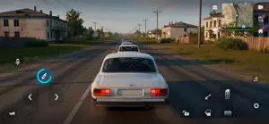 Cream Lada-style sedan on a country road past wooden houses and power lines