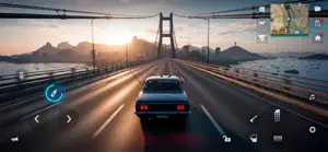 Dark sedan crossing a suspension bridge at sunset