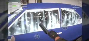 Looking through the open door of the blue sedan at falling snow with a tool in hand