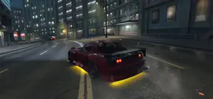 Tuned car with underglow parked on a city street at night