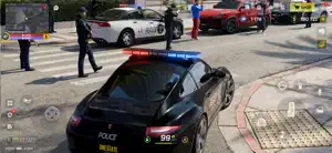 A black-and-white OneState police cruiser with lights on beside officers and a red sports car