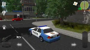 A police cruiser turning at a crossroads with parked cars and shops