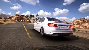 White saloon cruising toward a bend marked by chevrons in a rocky desert