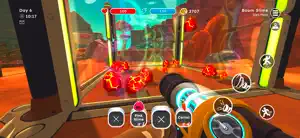 Ranch at night with a plort collector and a dozen red and pink slimes in the corral