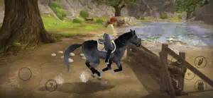Black horse galloping through a lakeside path under a large tree