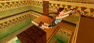 Lara leaping across an Egyptian tomb with hieroglyph-covered walls