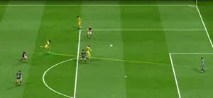 A striker breaking toward goal past a defender on a floodlit pitch