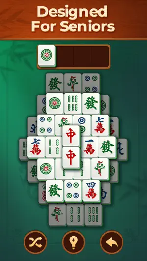 Mahjong solitaire board under a 'Designed For Seniors' banner, with one dot tile in a four-slot tray and shuffle, hint and undo buttons below