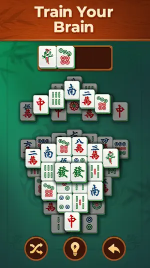 Two-part tile layout with a pair of green dragon tiles highlighted and two tiles in the tray, captioned 'Train Your Brain'