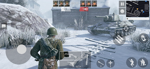 A Soviet soldier in the snow beside a T-34 outside a fortress gate