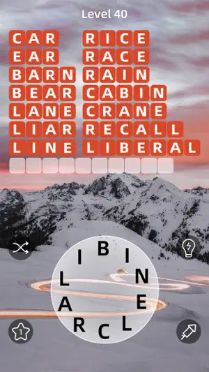 Level 40 with 14 words solved, from CAR and BARN to CRANE and LIBERAL, and one long slot left below snowy peaks